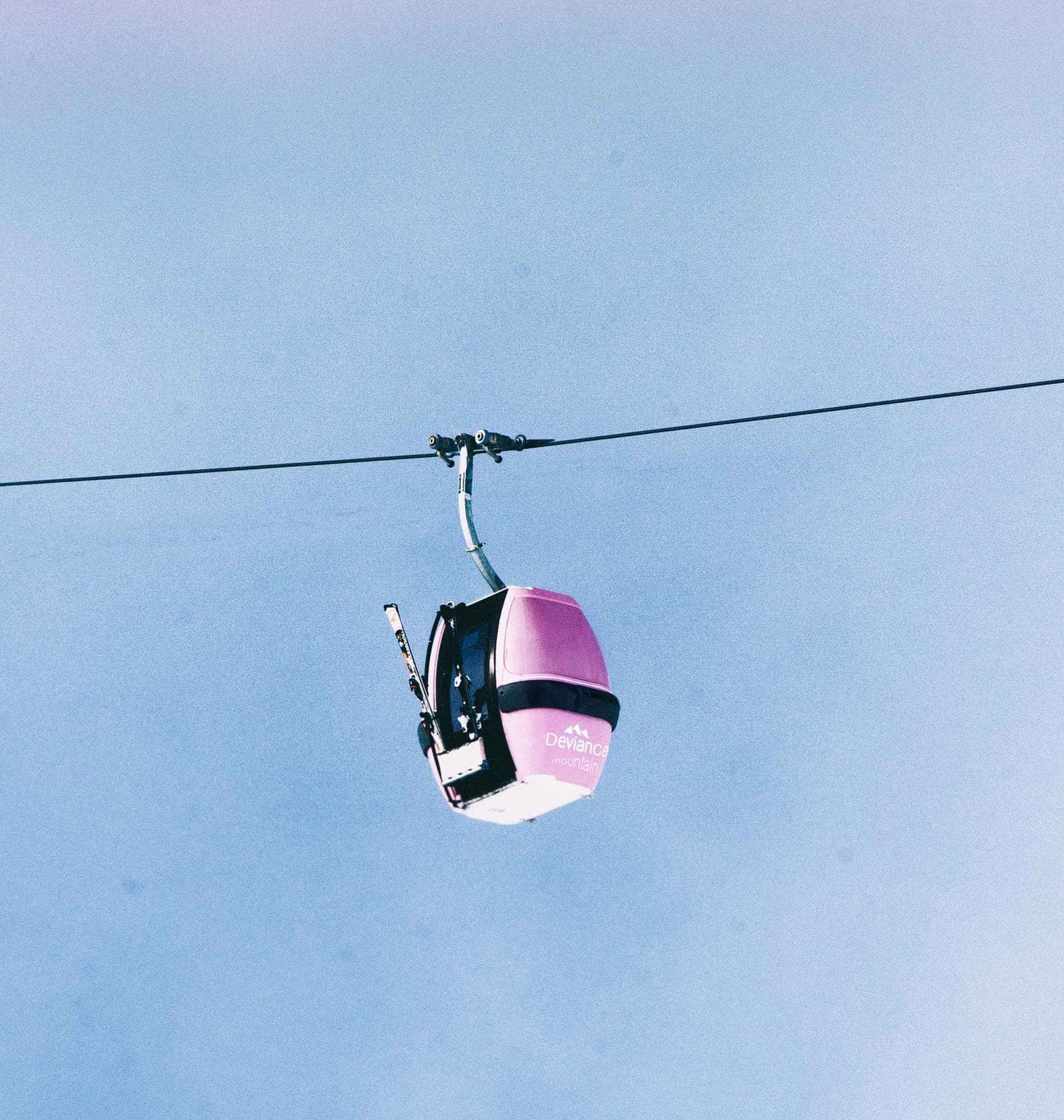 Gondola above the slopes, blue sky