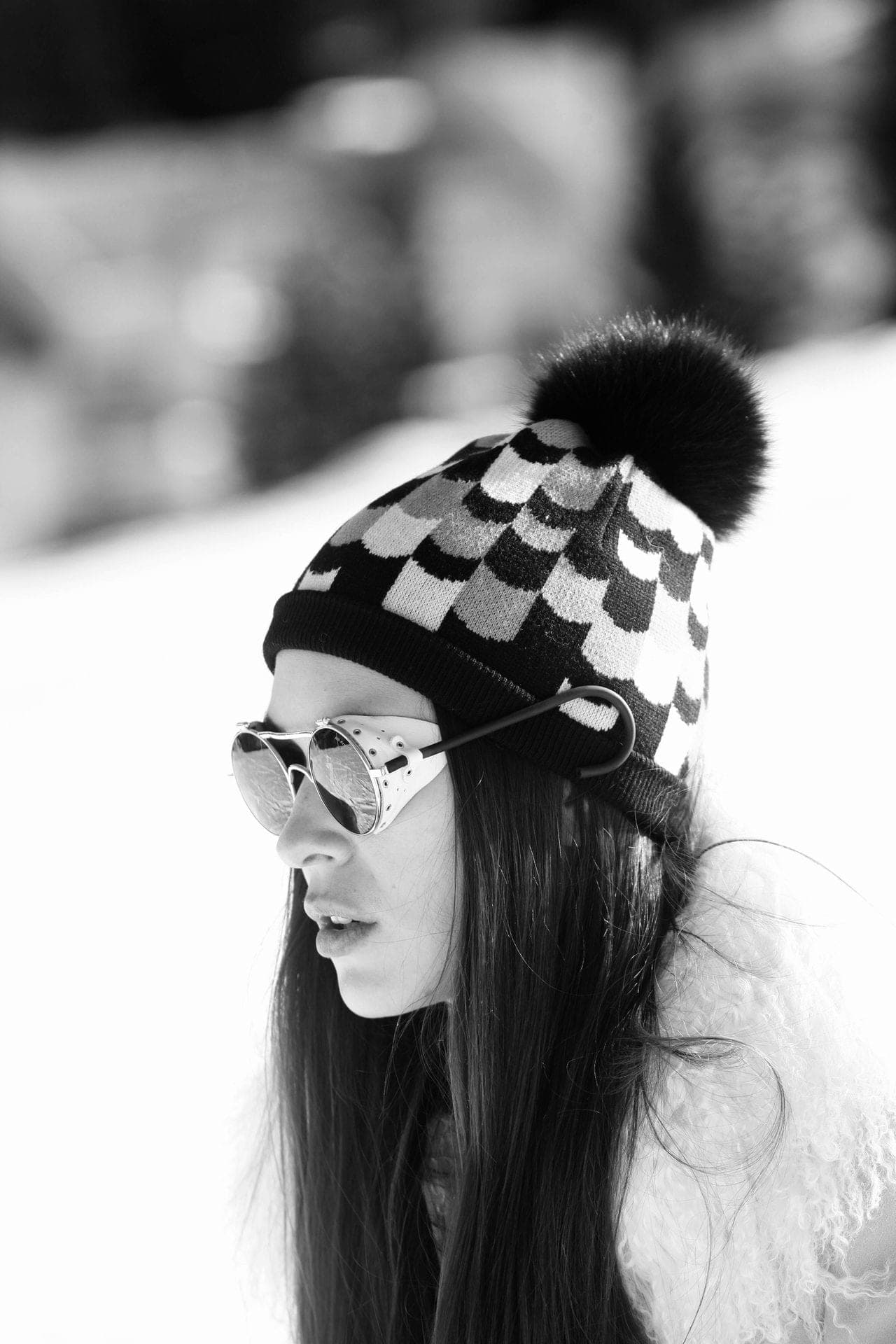 Black-and-white portrait, pompom hat and sunglasses
