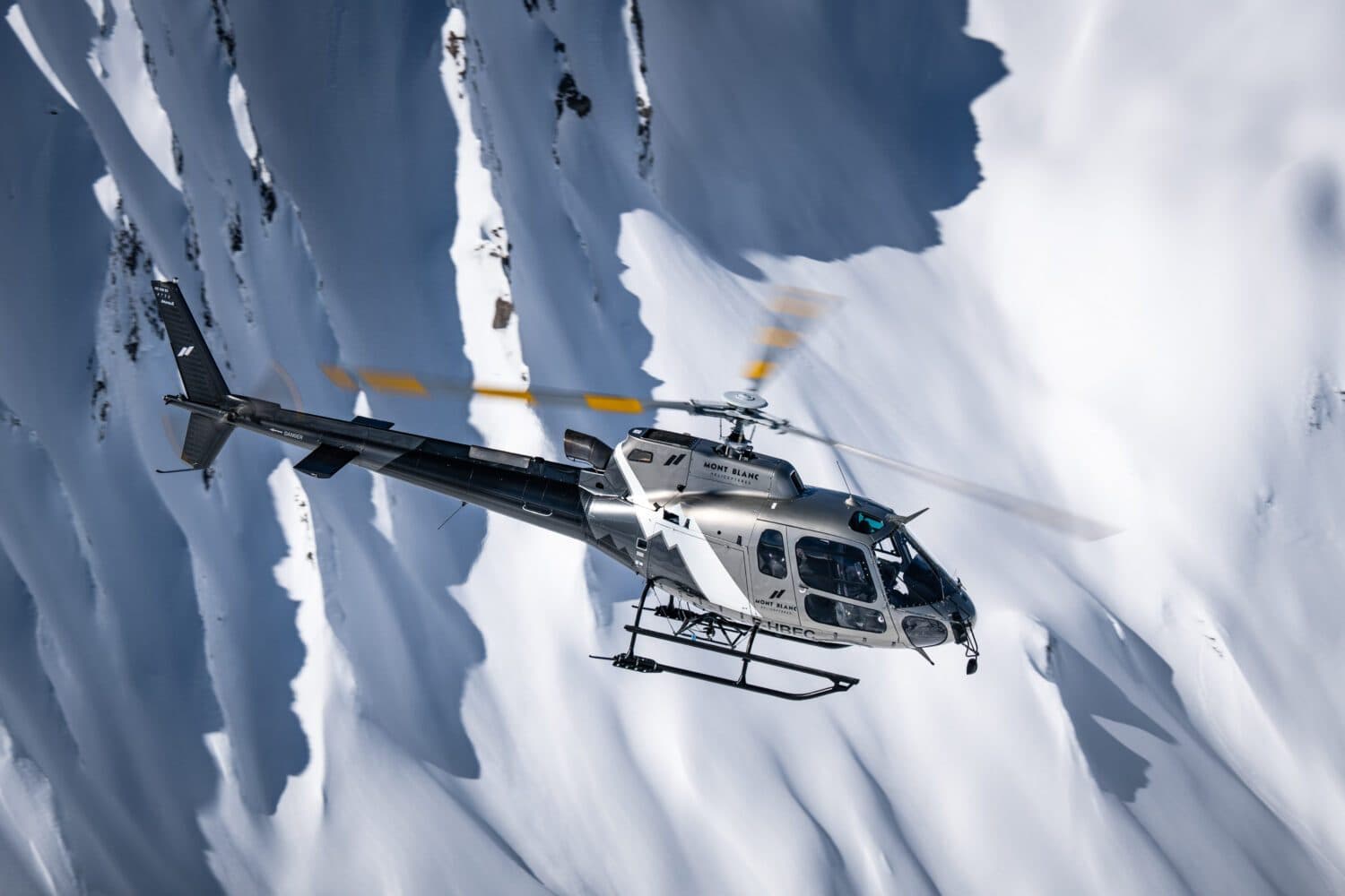 Helicopter flying over the snowy slopes of Courchevel